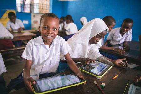 Pupil using government-issued tablet in class as part of innovation in learning, Muhaka Islamic Centre Kwale Kenya. 