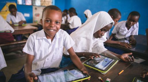 Pupil using government-issued tablet in class as part of innovation in learning, Muhaka Islamic Centre Kwale Kenya. 